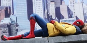 Spider-Man laying on a building in New York City